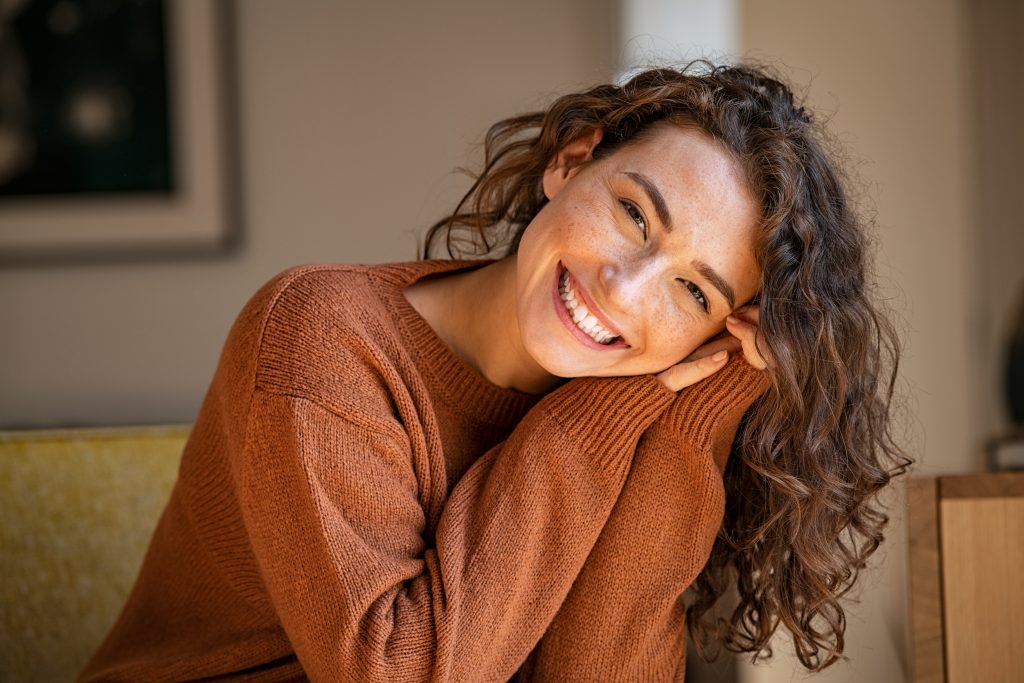 A happy woman sitting on a couch