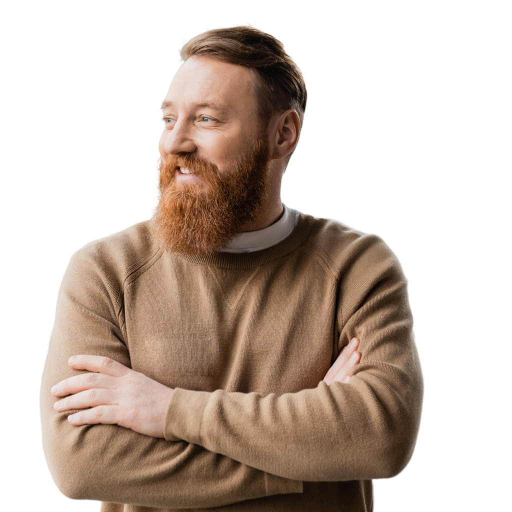 A smiling man with a red beard looking at something
